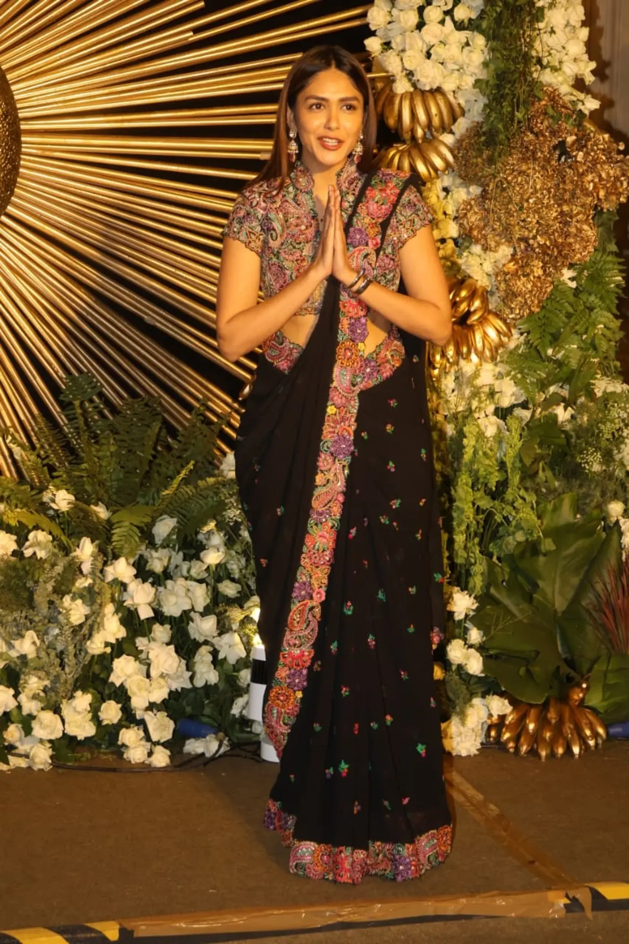 Mrunal Thakur made a graceful appearance at the Vijay–Rashmika reception, turning heads in a classic black saree with delicate floral embroidery. 